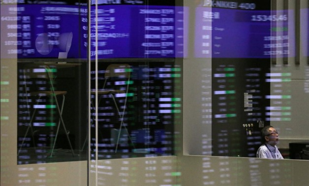 Market prices are reflected in a glass window at the Tokyo Stock Exchange (TSE) in Tokyo, Japan, February 6, 2018. REUTERS/Toru Hanai