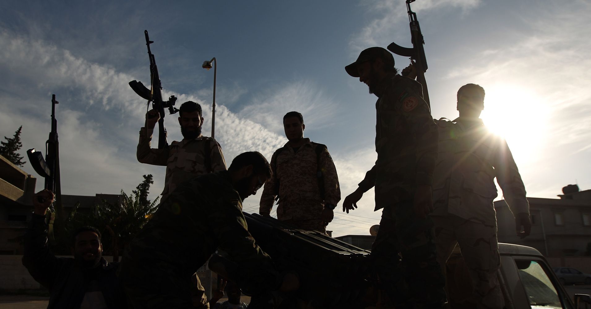 Members of a brigade headed by field commander Salah Bogheib and loyal to Khalifa Haftar -a retired general and former chief of staff for Moamer Kadhafi- hold up their guns as they fight alongside Libyan army troops against Islamist gunmen in the eastern Libyan city of Benghazi.