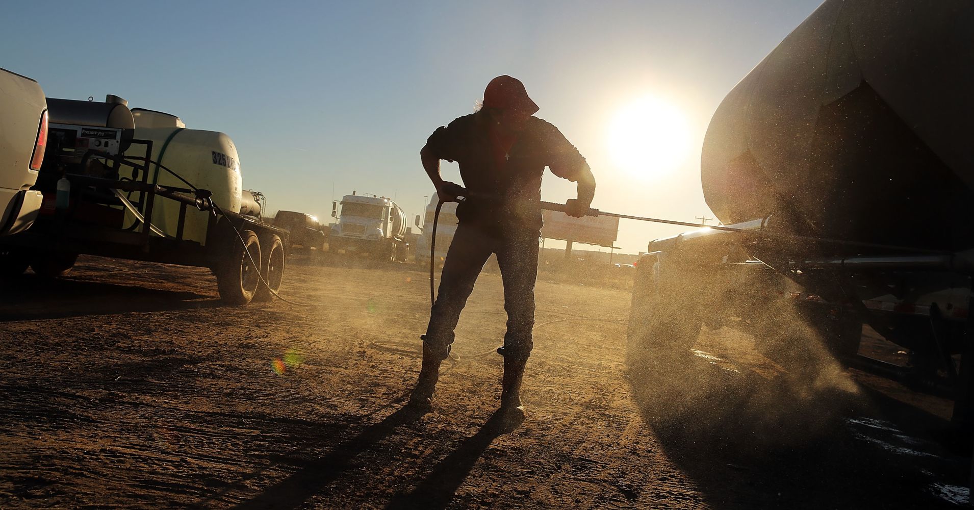 A truck used to carry sand for fracking is washed in a truck stop in Odessa, Texas.