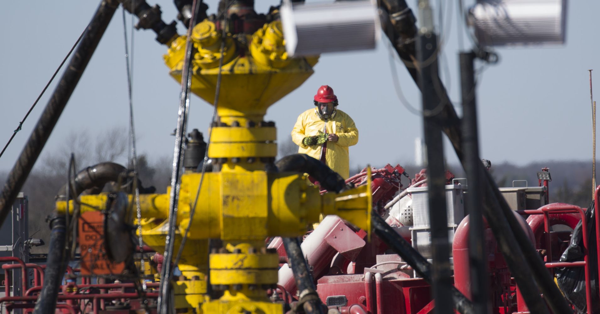 A Halliburton oil well fielder works on a well head at a fracking rig site January 27, 2016 near Stillwater, Oklahoma.