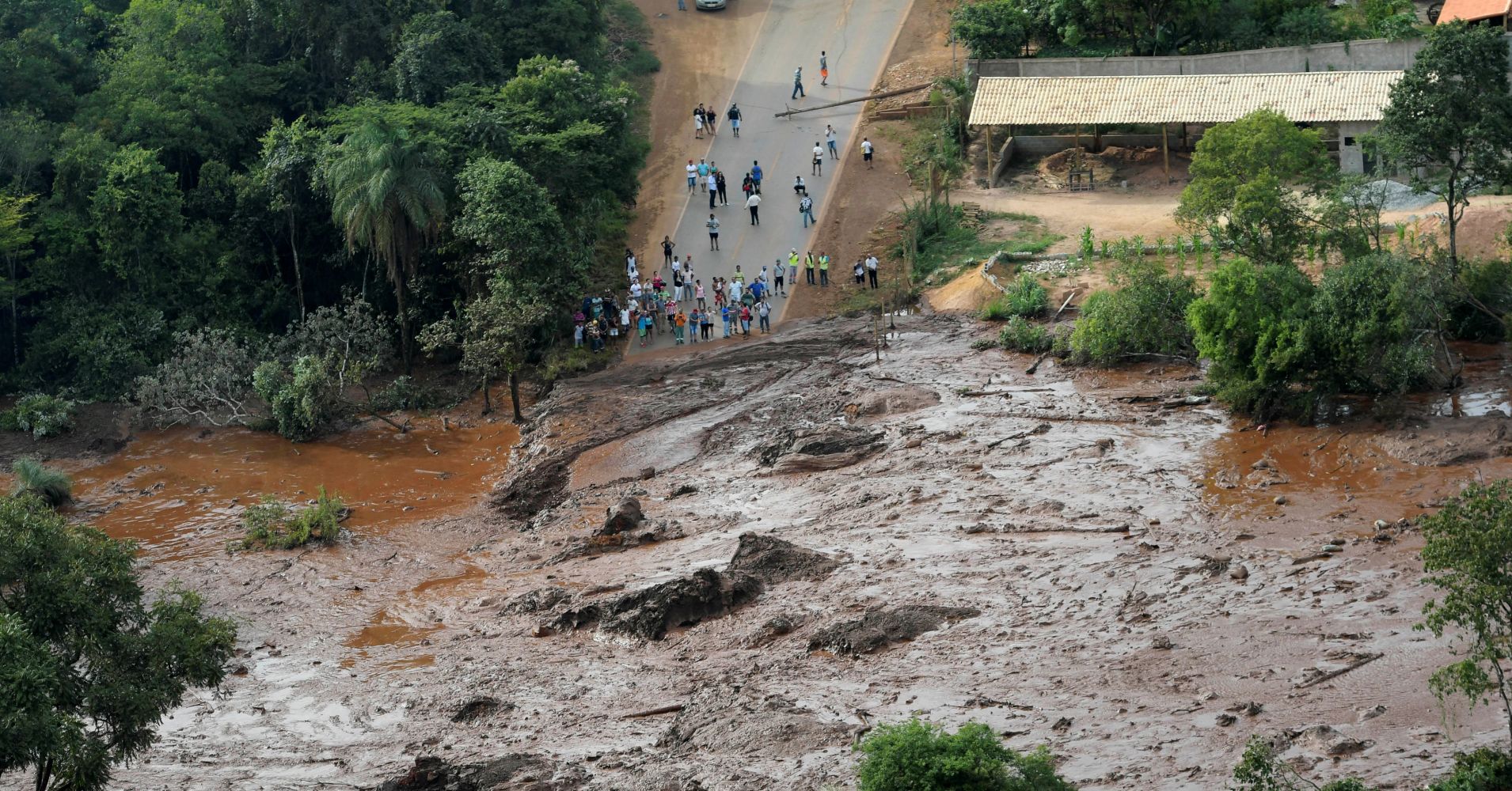 Residents are seen in an area next to a dam owned by Brazilian miner Vale SA that burst, in Brumadinho, Brazil January 25, 2019.