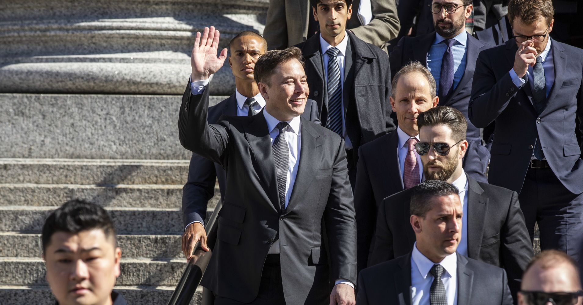 Elon Musk, chief executive officer of Tesla Inc., waves while departing from federal court in New York, U.S., on Thursday, April 4, 2019.