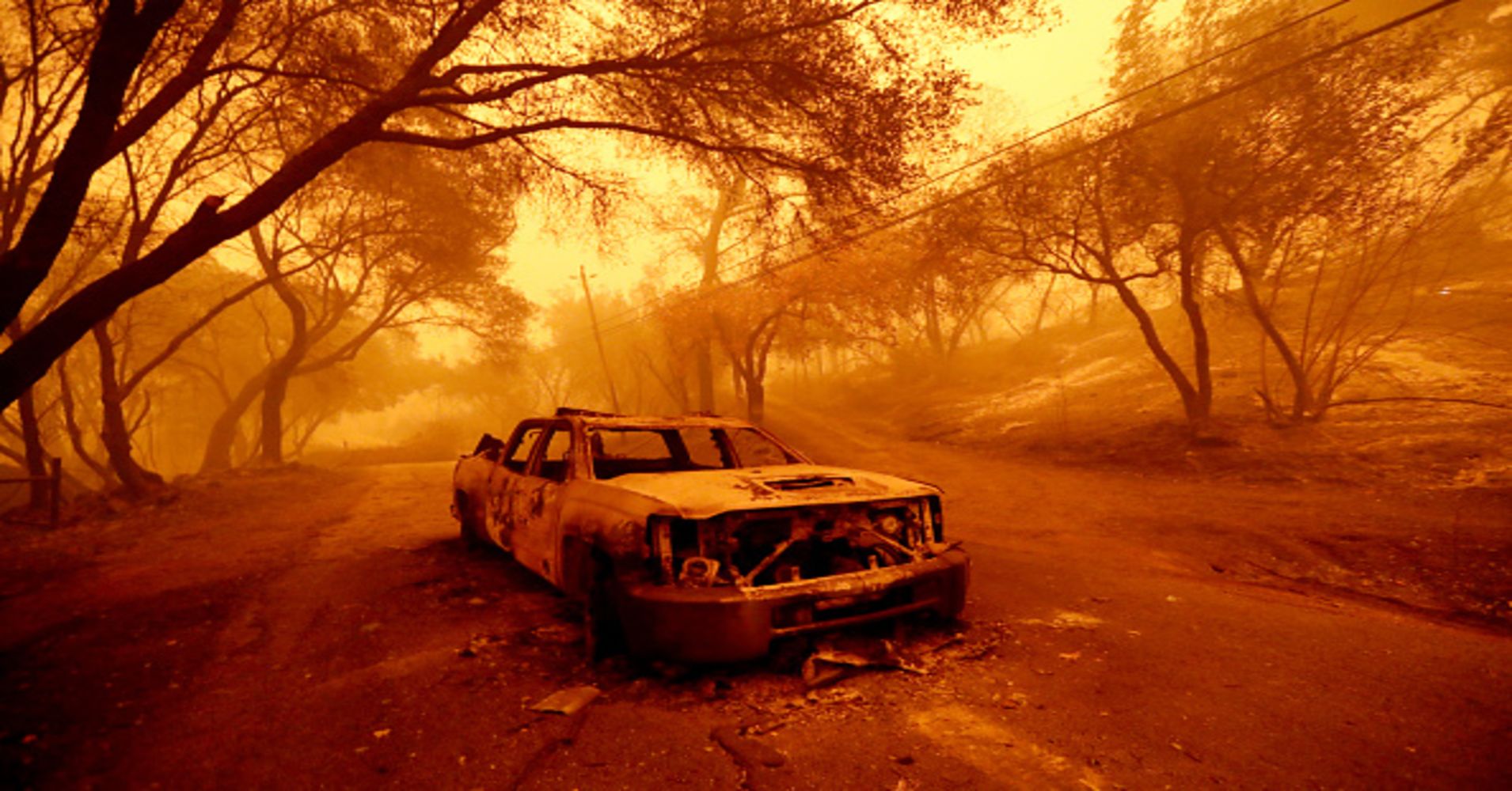 A charred vehicle was left in the middle of Honey Run Road as the Camp Fire continues with zero containment in Paradise, Calif., on Friday, Nov. 9, 2018.