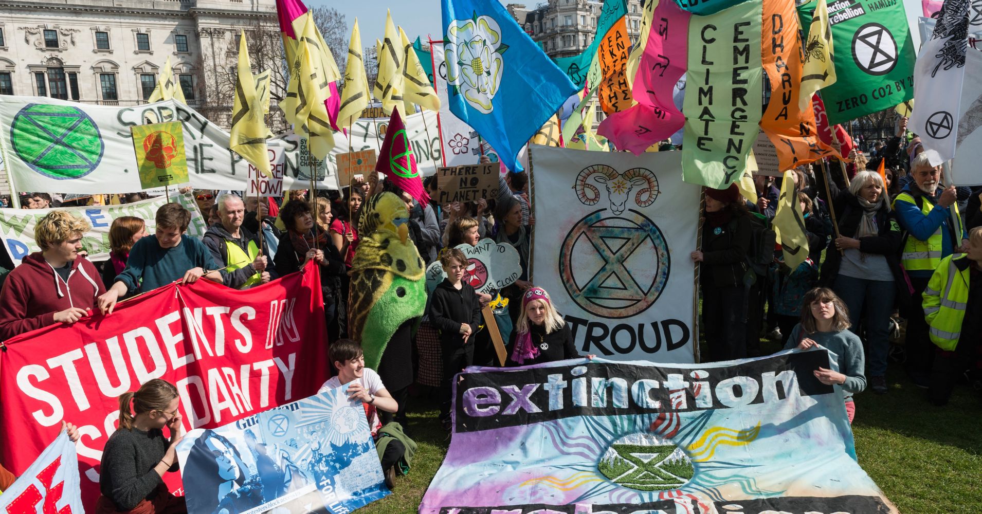 Environmental activists from Extinction Rebellion kick-off a day of action in Parliament Square with a colourful display of flags and banners, demanding creation of Citizens Assembly to propose effective ways for the UK to become carbon-neutral by 2025, on 15 April, 2019 in London, England.