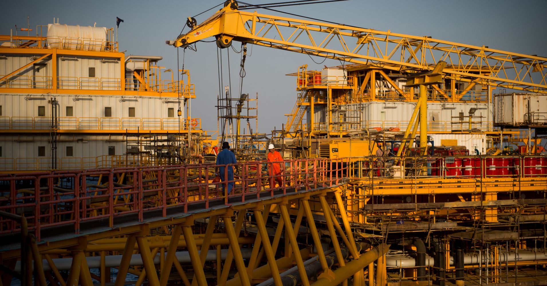 Workers cross walkways between zones aboard an offshore oil platform in the Persian Gulf's Salman Oil Field, operated by the National Iranian Offshore Oil Co., near Lavan island, Iran, on Thursday, Jan. 5. 2017.