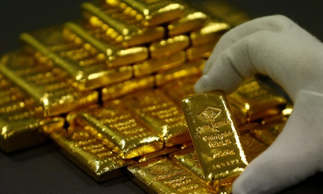 FILE PHOTO: An employee sorts gold bars in the Austrian Gold and Silver Separating Plant 'Oegussa' in Vienna, Austria, December 15, 2017. REUTERS/Leonhard Foeger