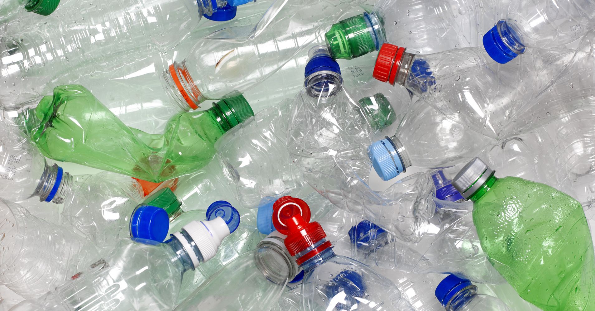 WATER BOTTLES IN RECYCLING BIN WITH RECYCLABLE CAPS