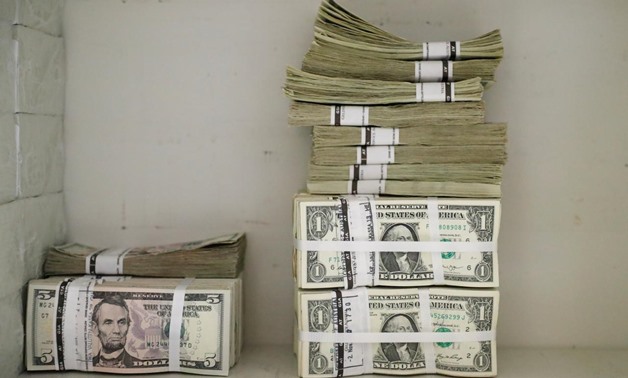 Wads of U.S. Dollar banknotes are stacked in piles at the Money Service Austria company's headquarters in Vienna, Austria, November 16, 2017. REUTERS/Leonhard Foeger