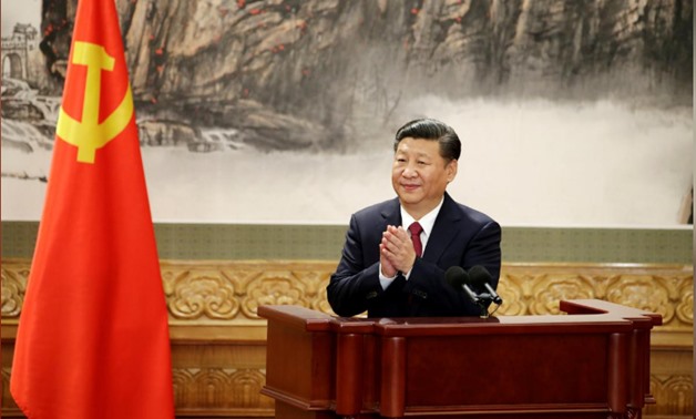 FILE PHOTO: Chinese President Xi Jinping claps after his speech as China's new Politburo Standing Committee members meet with the press at the Great Hall of the People in Beijing, China October 25, 2017. REUTERS/Jason Lee/File Photo