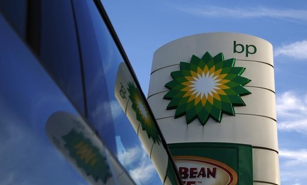 A BP logo is reflected in a car window at a petrol station in London- Luke MacGregor- Reuters